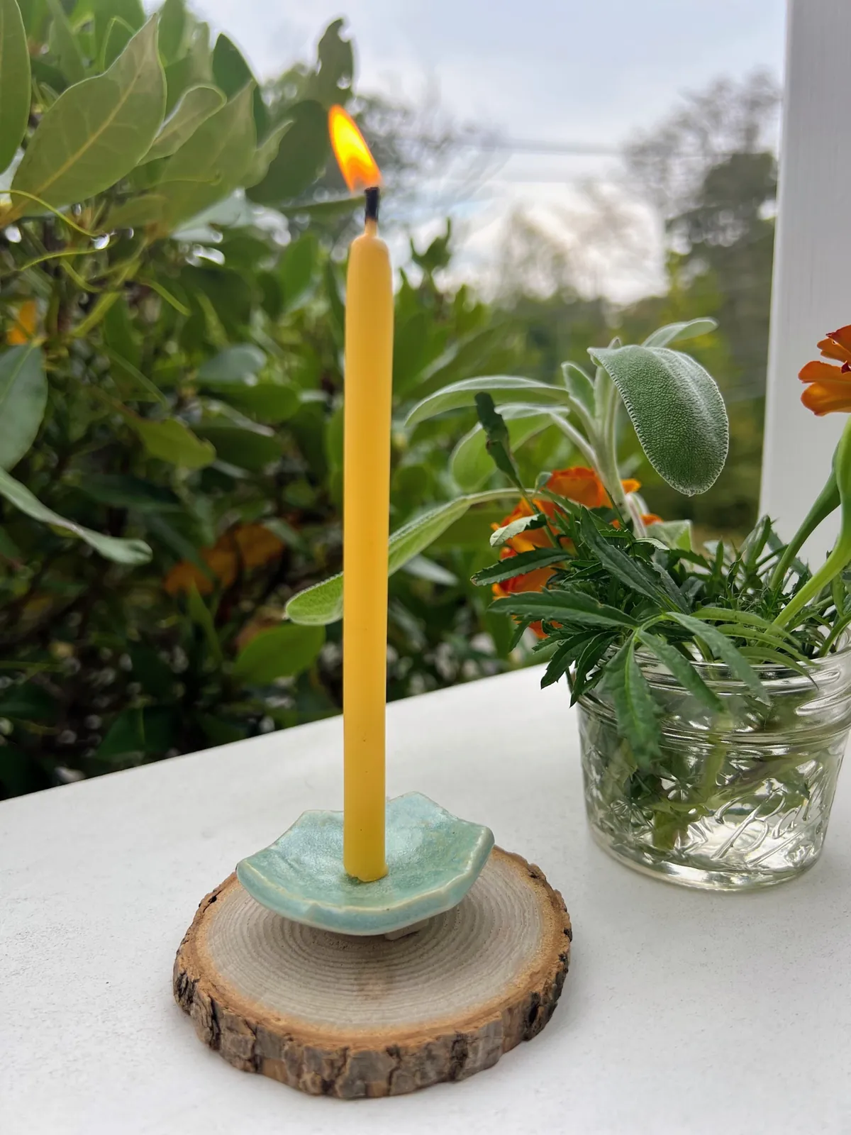 A freshly lit beeswax taper